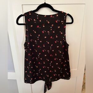 Women’s sleeveless blouse from Everly. Black with flowers, size large.
